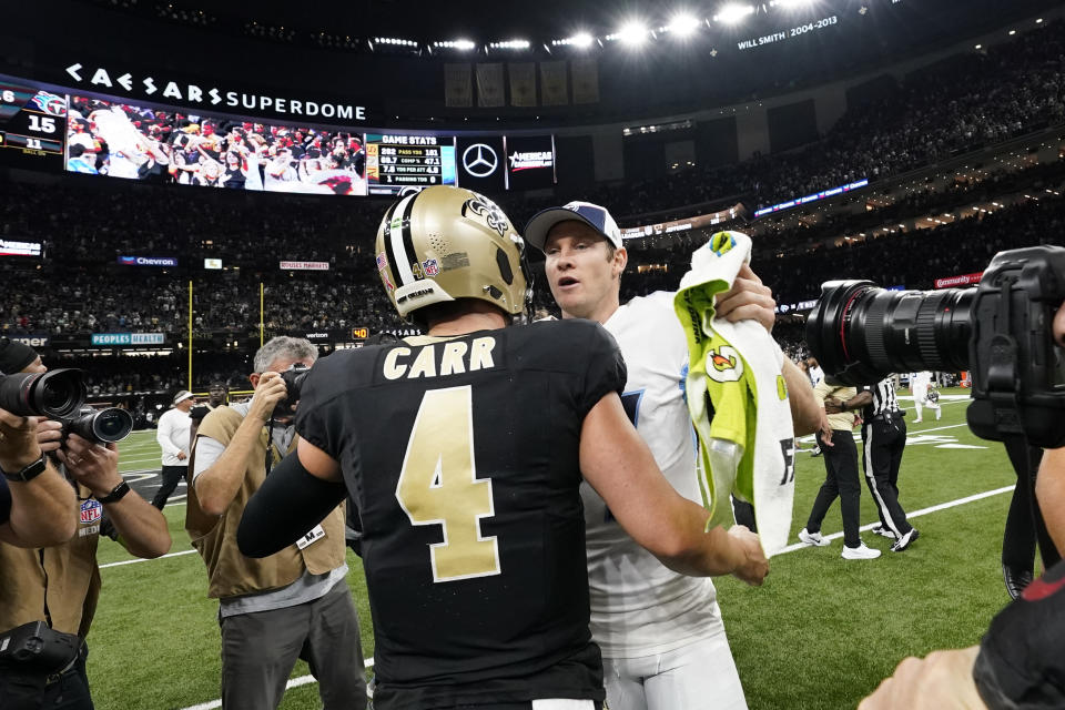 New Orleans Saints quarterback Derek Carr (4) and Tennessee Titans quarterback Ryan Tannehill, center right, meet at midfield after an NFL football game in New Orleans, Sunday, Sept. 10, 2023. (AP Photo/Gerald Herbert)