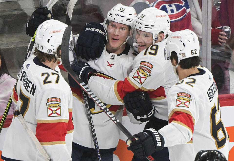 Florida Panthers' Anton Lundell (15) celebrates with teammates after scoring against the Montreal Canadiens during the third period of an NHL hockey game Thursday, March 30, 2023, in Montreal. (Graham Hughes/The Canadian Press via AP)