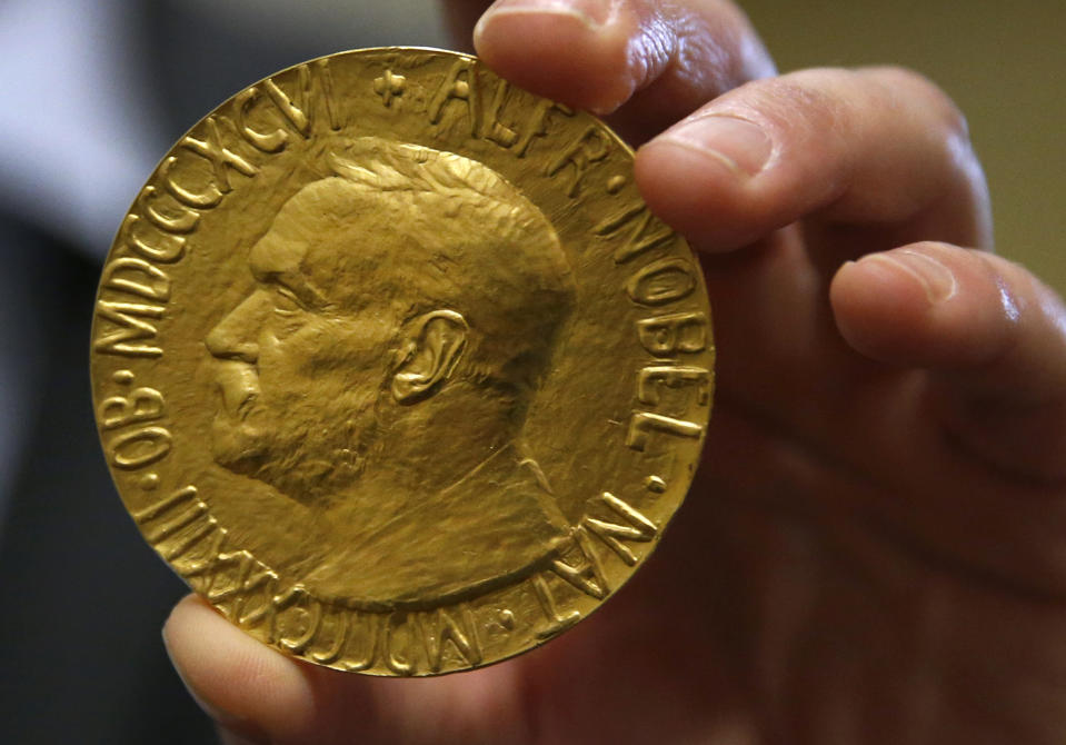 Bidder Ole Bjorn Fausa, of Norway, holds the 1936 Nobel Peace Prize in Baltimore, Thursday, March 27, 2014, the second Nobel Peace Prize ever to come to auction. The prize sold for a winning bid of $950,000 at auction, and an additional buyer’s commission brought the final sale price to $1.16 million. The recipient was Argentina's foreign minister, Carlos Saavedra Lamas, who was honored for his role in negotiating the end of the Chaco War between Paraguay and Bolivia. (AP Photo/Patrick Semansky)