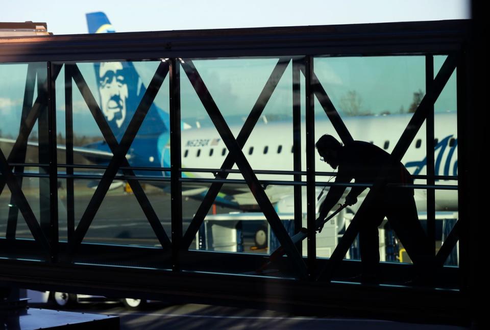 A worker cleans a jet bridge at Paine Field in Everett, Washington, before passengers board an Alaska Airlines flight (Copyright 2019 The Associated Press. All rights reserved.)