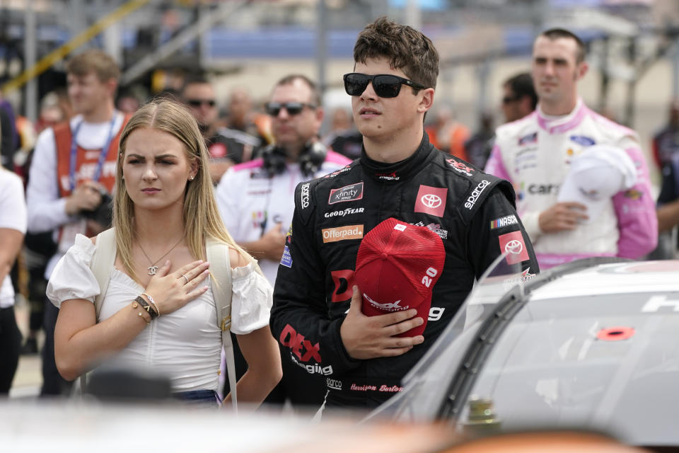 Harrison Burton, front right, stands for the national anthem before a NASCAR Xfinity Series auto race Saturday, June 19, 2021, in Lebanon, Tenn. (AP Photo/Mark Humphrey)