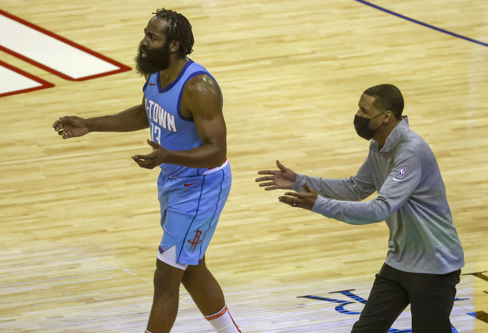Houston Rockets guard James Harden (13) and coach Stephen Silas, right, react after a play during the second quarter against the Los Angeles Lakers in an NBA basketball game Tuesday, Jan. 21, 2021, in Houston. (Troy Taormina/Pool Photo via AP)