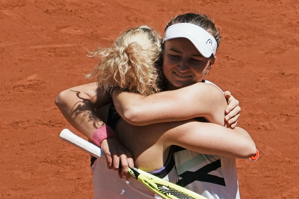 Czech Republic's Barbora Krejcikova, right, hugs compatriot Katerina Siniakova as they defeat USA's Bethanie Mattek-Sands and Poland's Iga Swiatek during their women's doubles final match of the French Open tennis tournament at the Roland Garros stadium Sunday, June 13, 2021 in Paris. (AP Photo/Thibault Camus)