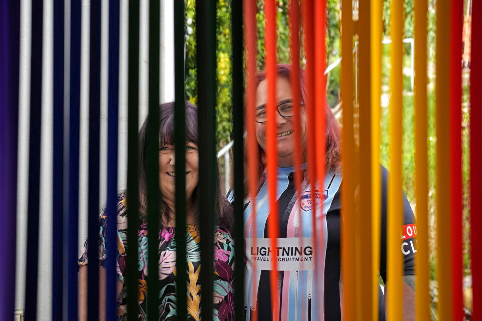 Avril Clark, left, and Lucy pose for a photograph during an interview at their house in London, Tuesday, June 11, 2024. Avril Clark operates the group Distinction Support, a U.K.-based global online network that helps people whose partner went through or is undergoing a gender transition. Her spouse, a British soccer referee at the time, came out publicly as transgender in 2018, changed her name to Lucy and brought the couple much attention. Avril Clark says that until then, they kept their arrangement private and "lived a double life" for 15 years. (AP Photo/Kin Cheung)