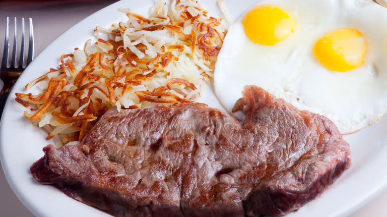 plate of prepared eggs, steak and hashbrowns
