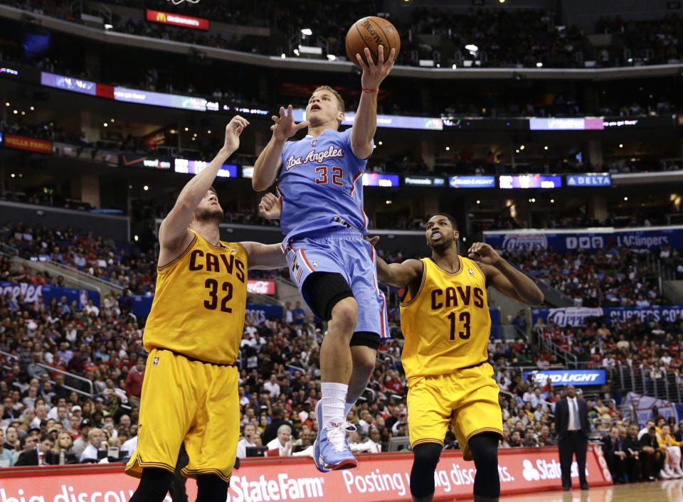 Los Angeles Clippers's Blake Griffin, center, drives to the basket past Cleveland Cavaliers's Spencer Hawes, left, and Tristan Thompson during the first half of an NBA basketball game on Sunday, March 16, 2014, in Los Angeles. (AP Photo/Jae C. Hong)