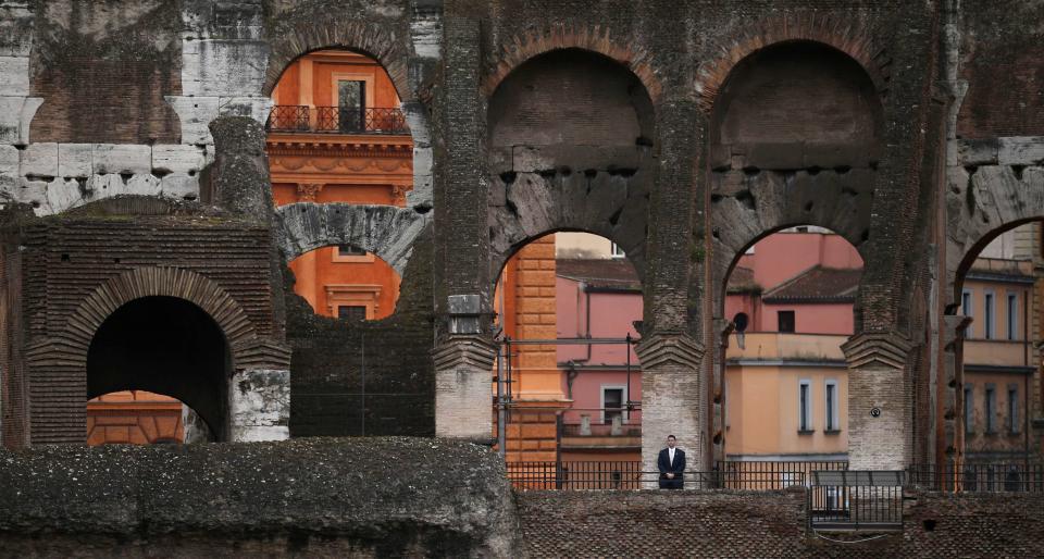 Secret Service agent keeps watch as President Obama tours the Colosseum in Rome