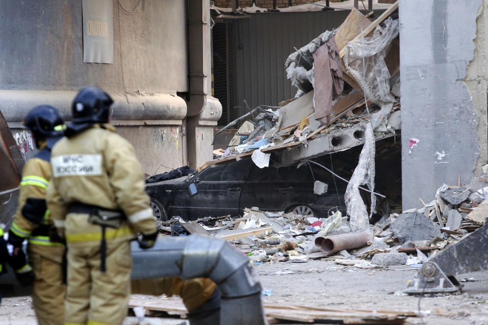 Emergency Situations employees look towards debris of damaged parts of a collapsed apartment building in Magnitogorsk, a city of 400,000 people, about 1,400 kilometers (870 miles) southeast of Moscow, Russia, Wednesday, Jan. 2, 2019. Search crews have pulled more bodies from a huge pile of rubble at a collapsed Russian apartment building. The building's pre-dawn collapse on Monday came after an explosion that was believed to have been caused by a gas leak. (AP Photo/Maxim Shmakov)