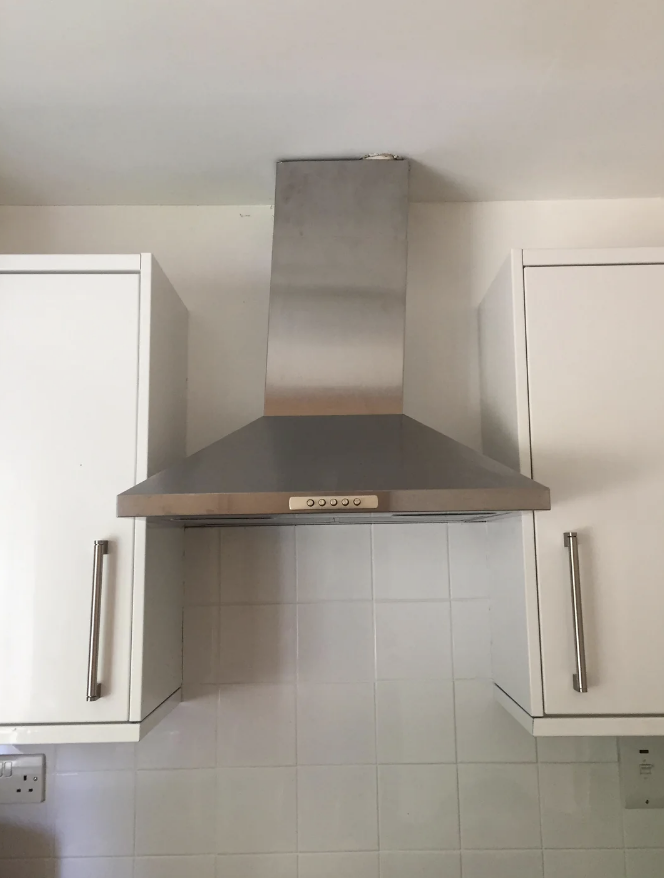 Steel range hood bent in the kitchen