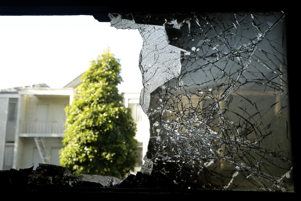 A broken window is shown at the damaged entrance to the Chinese Consulate in San Francisco on Thursday, Jan. 2, 2014. The consulate said Thursday that its compound was damaged in an arson attack and urged American authorities to protect the safety of its diplomats and its premises. (AP Photo/Jeff Chiu)