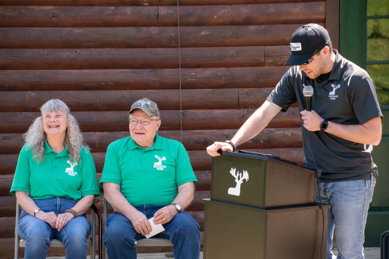 Luke Fabian (right), educational director at Deerassic Park, honors LouAnn and Alan Huthmaker at the Deerassic Nature Center. The center was renamed after the Huthmakers for their years of dedication to the park.