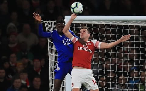 Arsenal's Rob Holding is lucky not to give away a penalty for this handball - Credit: PA