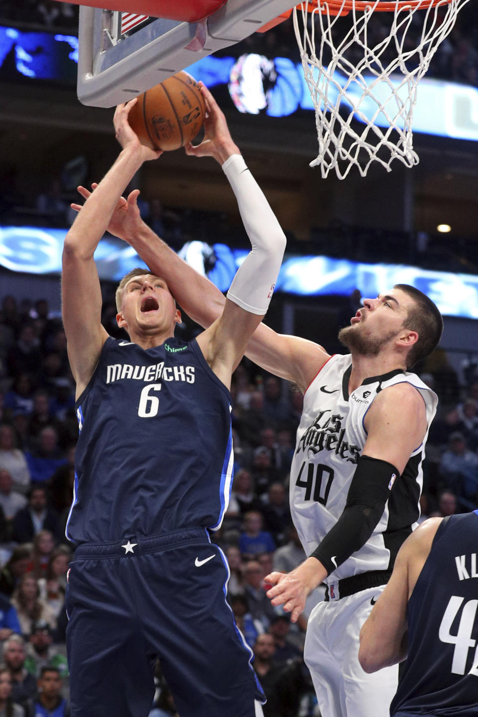 Dallas Mavericks forward Kristaps Porzingis (6) gets fouled as he goes up for a shot against Los Angeles Clippers center Ivica Zubac (40) during the first half of an NBA basketball game Tuesday, Jan. 21, 2020 in Dallas. (AP Photo/Richard W. Rodriguez)