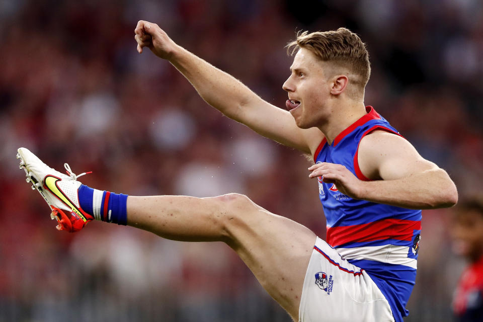 Pictured here, Western Bulldogs star Lachie Hunter kicking the ball during the 2021 AFL grand final against the Melbourne Demons. 