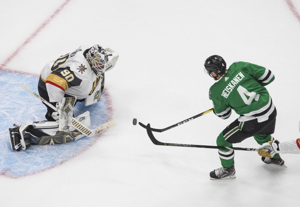 Dallas Stars' Miro Heiskanen (4) is stopped by Vegas Golden Knights goalie Robin Lehner (90) during the third period of Game 4 of the NHL hockey Western Conference final, Saturday, Sept. 12, 2020, in Edmonton, Alberta. (Jason Franson/The Canadian Press via AP)