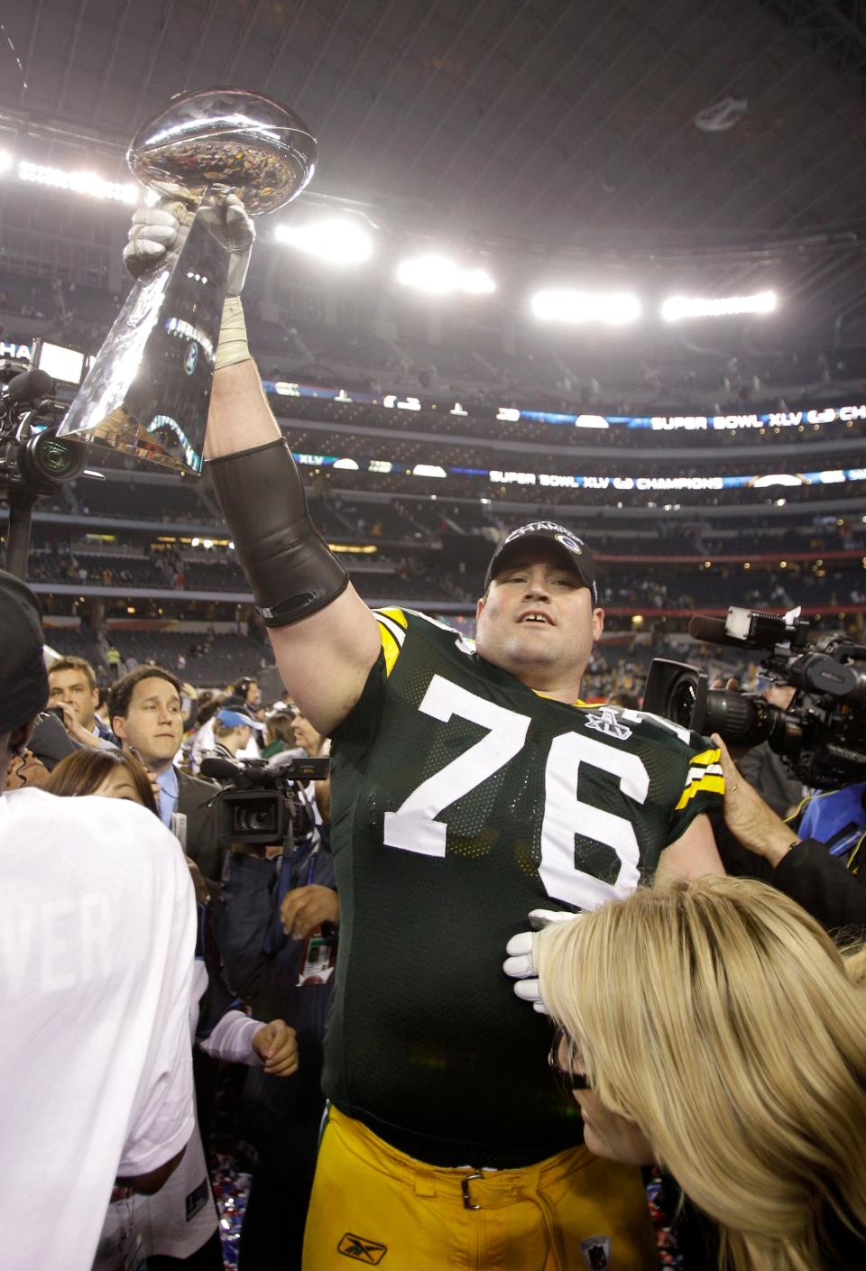 Green Bay Packers tackle Chad Clifton holds up the Vince Lombardi Trophy following the Packers' 31-25 win against the Pittsburgh Steelers in Super Bowl XLV in 2011.