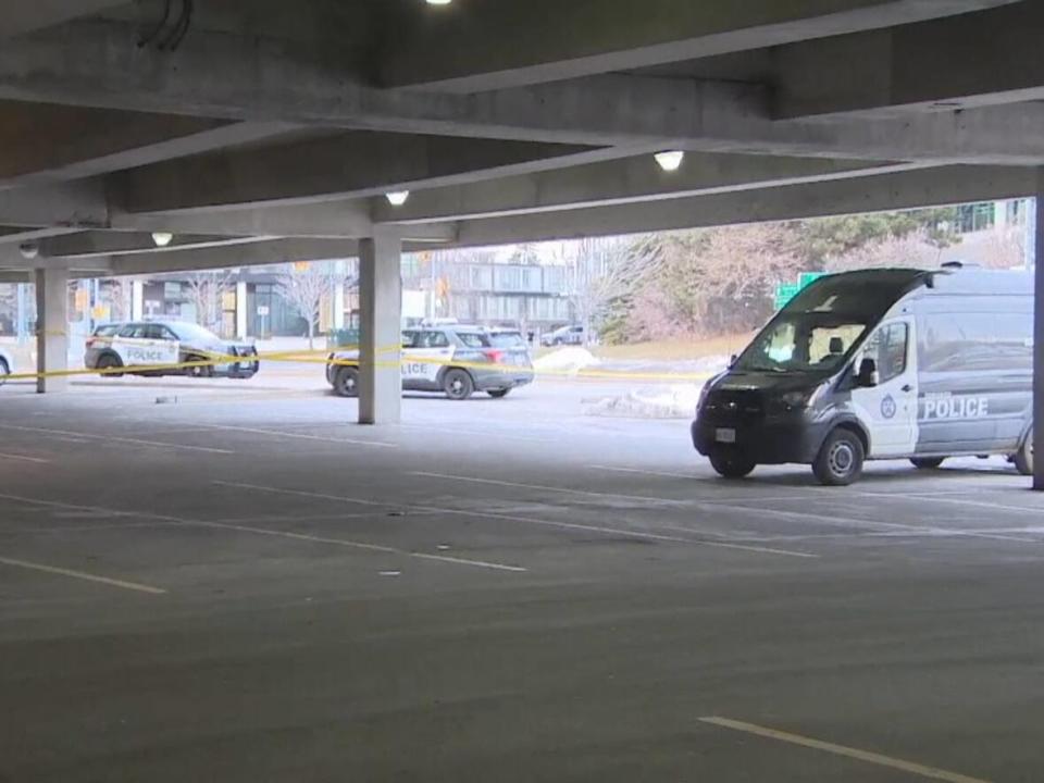 Toronto police vehicles are parked near the scene of a triple shooting on Monday. Three men in their 20s were shot. One has died in hospital. The shooting occurred at a parking garage in a shopping mall. (Hugo Levesque/CBC - image credit)