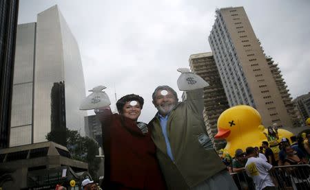 Cardboard cutouts depicting Brazil's former President Luiz Inacio Lula da Silva (R) and Brazil's President Dilma Rousseff are seen during a protest against Rousseff, part of nationwide protests calling for her impeachment, in Sao Paulo, Brazil, March 13, 2016. REUTERS/Nacho Doce