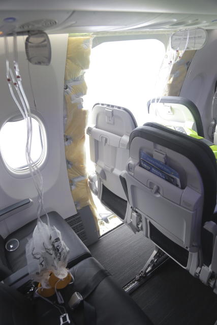 This photo released by the National Transportation Safety Board shows a gaping hole where the paneled-over door had been at the fuselage plug area of Alaska Airlines Flight 1282 on Sunday, Jan. 7, 2024, in Portland, Ore. A panel used to plug an area reserved for an exit door on the Boeing 737 Max 9 jetliner blew out Jan. 5, shortly after the flight took off from Portland, forcing the plane to return to Portland International Airport. (National Transportation Safety Board via AP)