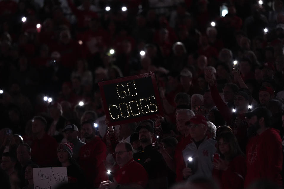 Houston fans light up the arena as the team runs onto the court for an NCAA college basketball game against Texas Saturday, Feb. 17, 2024, in Houston. (AP Photo/David J. Phillip)