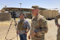 In this May 21, 2021, photo Col. Scott Desormeaux, who is with the Louisiana National Guard, talks to reporters in northern Syria during a visit by Marine Gen. Frank McKenzie, top U.S. commander for the Middle East. The Syria deployment is just one of many missions the Louisiana Guard had to juggle over the past year. Listening at left is ABC correspondent Luis Martinez. (AP Photo/Lolita Baldor)