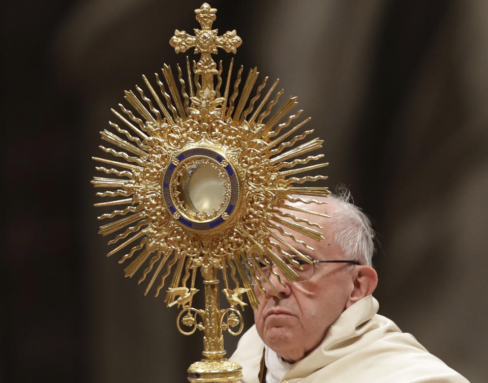 Pope Francis holds a monstrance as he celebrates a new year's eve vespers Mass in St. Peter's Basilica at the Vatican, Saturday, Dec. 31, 2016. (AP Photo/Andrew Medichini)