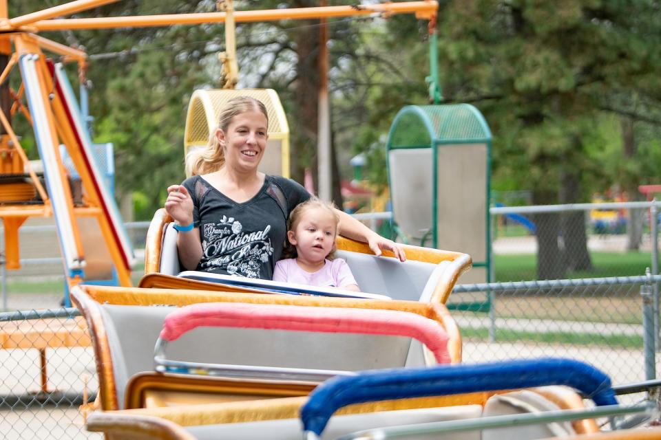 Larissa Peacock and Paisley Peacock, 3, ride the mini rollercoaster at Pueblo City Park on Saturday, May 13, 2023.