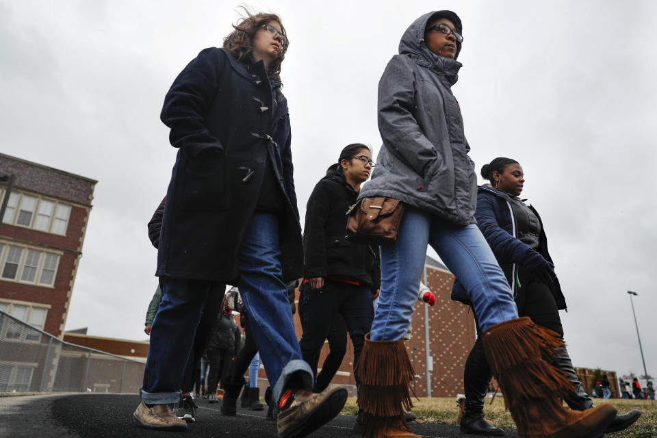 <p>Students gather on their soccer field during a 17-minute walkout protest at the Stivers School for the Arts, Wednesday, March 14, 2018, in Dayton, Ohio. Students across the country planned to participate in walkouts Wednesday to protest gun violence, one month after the deadly shooting inside a high school in Parkland, Fla. (Photo: John Minchillo/AP) </p>