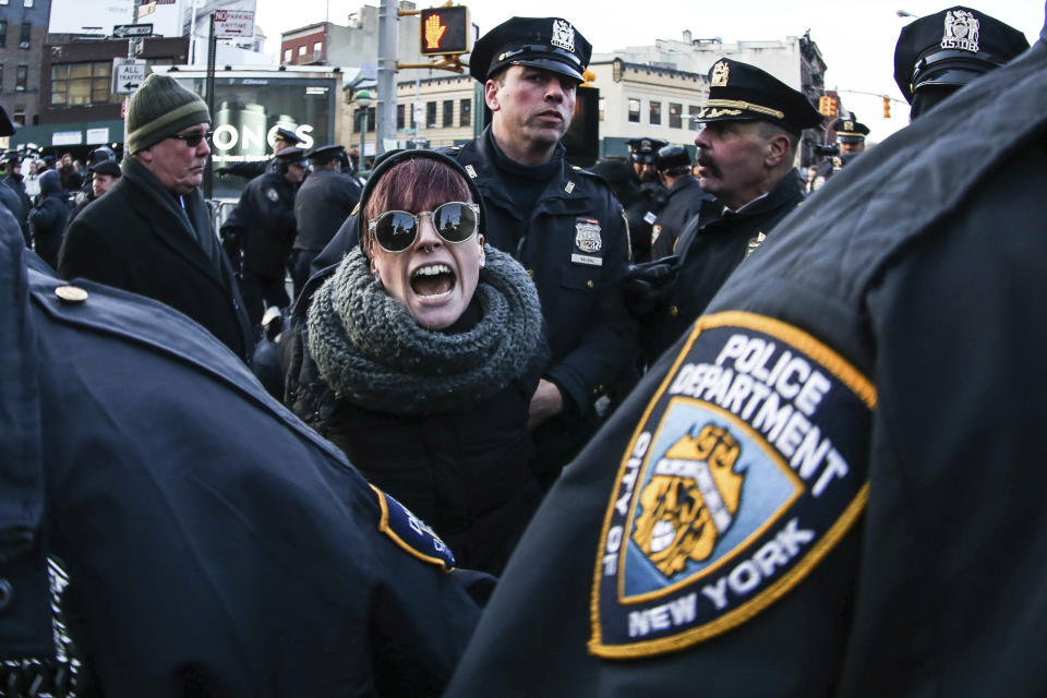 A woman is arrested by police officers during a demonstration to protest against President Donald Trump's Executive Order banning immigrants and refugees from seven Muslim-majority countries and the LGBT community at Stonewall on Feb. 04, 2017 in New York City.