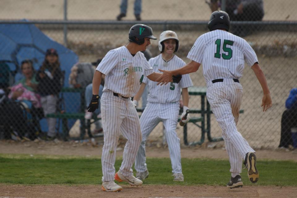 Victor Valley’s Ben Seidenkranz, right, and Jorge Avila celebrate after scoring runs during the fourth inning on Wednesday, April 12, 2023. Victor Valley defeated Barstow 6-3.