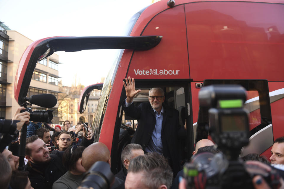 Labour Party leader Jeremy Corbyn waves from his rally bus after speaking at a rally outside Bristol City Council while on the General Election campaign trail, in Bristol, England, Monday, Dec. 9, 2019. Britain goes to the polls on Dec. 12. (Joe Giddens/PA via AP)