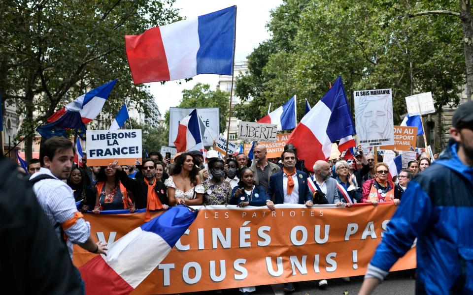 People march during a demonstration against the mandatory Covid-19 health pass - STEPHANE DE SAKUTIN/AFP