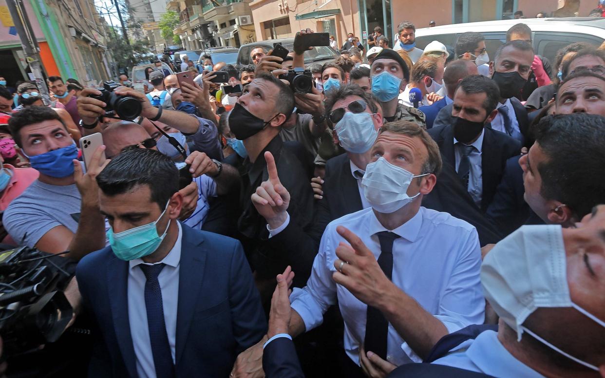French President Emmanuel Macron toured heavily damaged Beirut neighbourhoods on Thursday - AFP