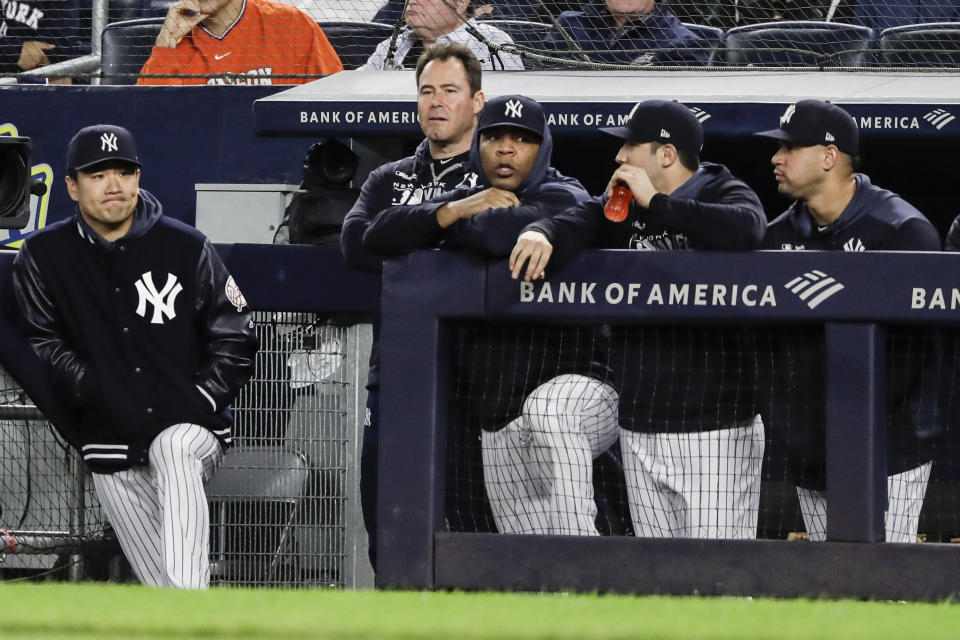 New York Yankees starting pitcher Masahiro Tanaka, of Japan, left, watches with teammates during the ninth inning of the team's baseball game against the Los Angeles Angels on Wednesday, Sept. 18, 2019, in New York. The Angels won 3-2. (AP Photo/Frank Franklin II)