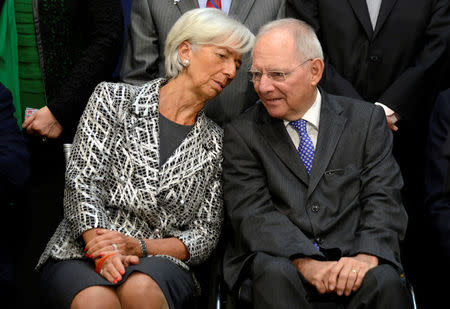 IMF Managing Director Christine Lagarde (L) chats with German Finance Minister Wolfgang Schauble as they take their seats for a "family" photo for the International Monetary and Financial Committee (IMFC), as part of the IMF and World Bank's 2017 Annual Spring Meetings, in Washington, U.S., April 22, 2017. REUTERS/Mike Theiler