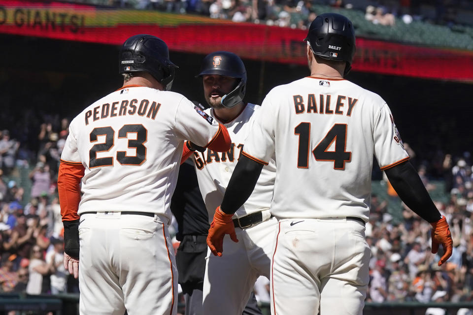 San Francisco Giants' J.D. Davis, middle, celebrates after hitting a three-run home run that scored Joc Pederson (23) and Patrick Bailey (14) during the eighth inning of a baseball game against the Cleveland Guardians in San Francisco, Wednesday, Sept. 13, 2023. (AP Photo/Jeff Chiu)