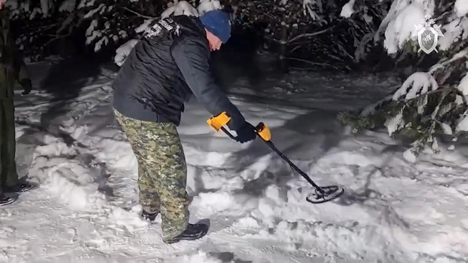 In this photo taken from video released by Russian Investigative Committee on Wednesday, Dec. 6, 2023, investigators work at the place where Illia Kyva was killed in a cottage village near Moscow, Russia. Kyva, a former member of Ukraine's parliament who had called for Kyiv to surrender when Russian troops invaded the country in February 2022, was found on Wednesday with a gunshot wound to the head in a cottage village near Moscow. (Russian Investigative Committee via AP)