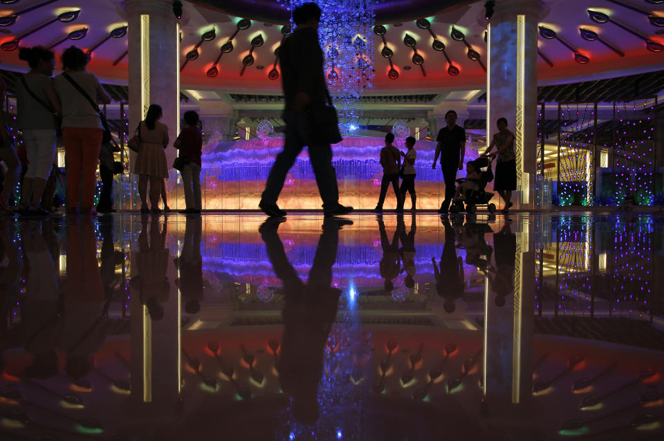 In this June 5, 2013 photo, Mainland Chinese visitors gather at the lobby of the Galaxy casino in Macau. Macau is in the midst of one of the greatest gambling booms the world has ever known. To rival it, Las Vegas would have to attract six times as many visitors essentially every man, woman and child in America. Wynn Las Vegas now makes nearly three-quarters of its profits in Macau. Sands, which owns the Venetian and Palazzo, earns two-thirds of its revenue there. (AP Photo/Vincent Yu)