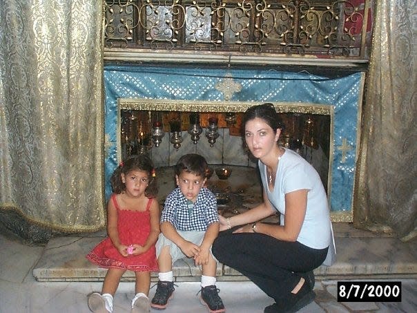 Des Moines Register journalist Andrea Sahouri photographed in Bethlehem with her brother, Alex Sahouri, and mother, Muna Tareh-Sahouri, during a childhood visit to Palestine.