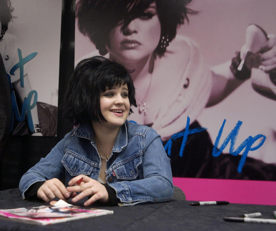 Kelly Osbourne savors the moment during an in store appearance to mark the release of her new CD "Shut Up!" at Tower Records in Los Angeles November 30, 2002. The second season opener of MTV's hit reality series "The Osbourne's," which features Kelly, her brother Jack and their parents Ozzy and Sharon, drew an average of 6.6 million viewers, making it the most watched cable TV program of the night, the network said November 26. REUTERS/Jim Ruymen JR