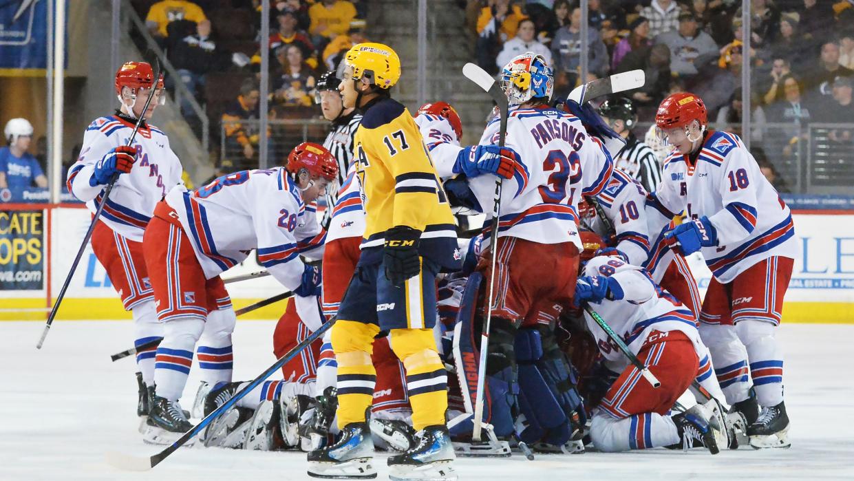 Erie Otters forward Malcolm Spence, center, skates by Kitchener Rangers teammates as they celebrate a 4-3 overtime win to end an Ontario Hockey League Western Conference quarterfinal game at Erie Insurance Arena.