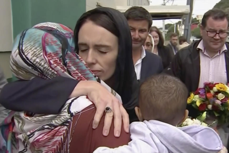 FILE - In this Sunday, March 17, 2019 image made from video, New Zealand's Prime Minister Jacinda Ardern, center, hugs and consoles a woman as she visited Kilbirnie Mosque, in Wellington. Ardern was hailed around the world for her decisive response to the two mosque shootings by a white nationalist who killed 50 worshippers. For many Muslims, her most consequential move was immediately labeling the attack an act of terrorism. Community leaders and researchers say that for too long, terrorism was considered a "Muslim problem" and that a double standard persists when attacker is white and non-Muslim. (TVNZ via AP, File)