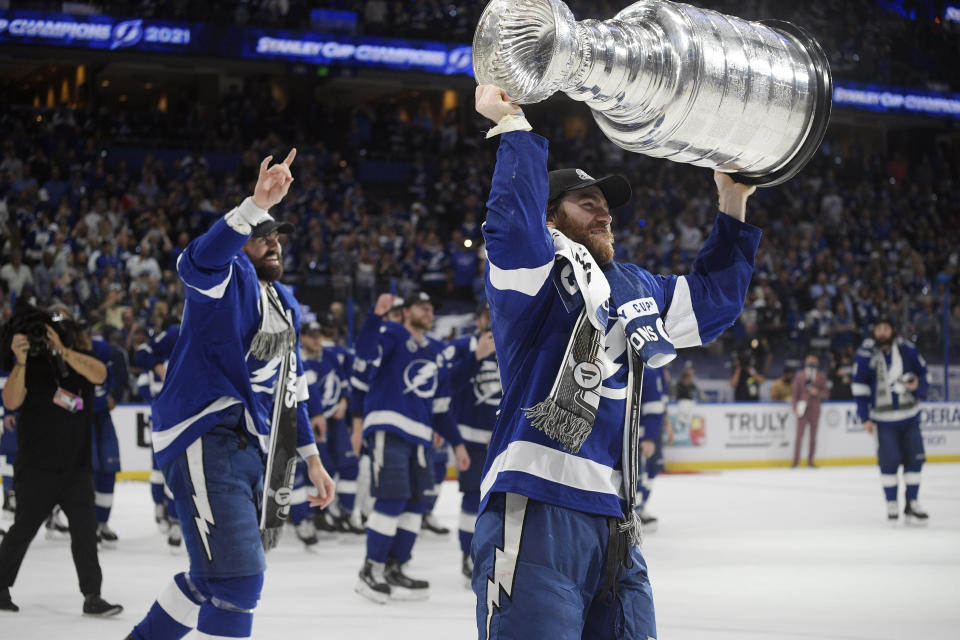 FILE - In this July 7, 2021, file photo, Tampa Bay Lightning center Brayden Point hoists the Stanley Cup after the team defeated the Montreal Canadiens in Game 5 of the NHL hockey Stanley Cup finals in Tampa, Fla. (AP Photo/Phelan Ebenhack, File)