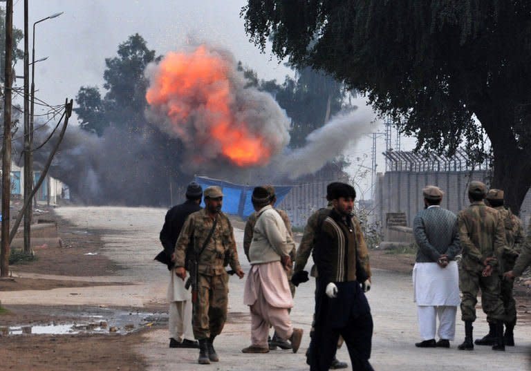 Troops detonate a bomb that failed to go off during an assault by militants near Peshawar airport in northwest Pakistan on December 16, 2012. Six people were killed Sunday as police and troops battled militants armed with automatic weapons, grenades and mortars in Peshawar, a day after a deadly Taliban raid on the city's airport