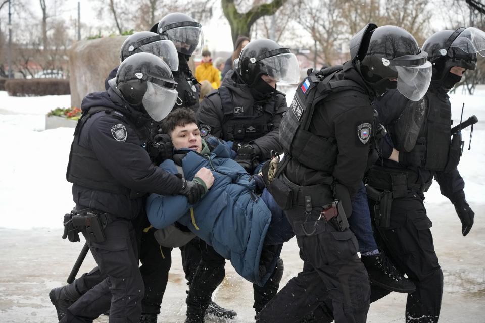 FILE - Police detain a man as he wanted to lay flowers to honor Russian opposition leader Alexei Navalny in St. Petersburg, Russia on Saturday, Feb. 17, 2024. Kremlin critics say Russian law enforcement agencies' focus on stifling political opposition contributed to their failure to prevent the March 22 attack on a Moscow concert hall. (AP Photo, File)
