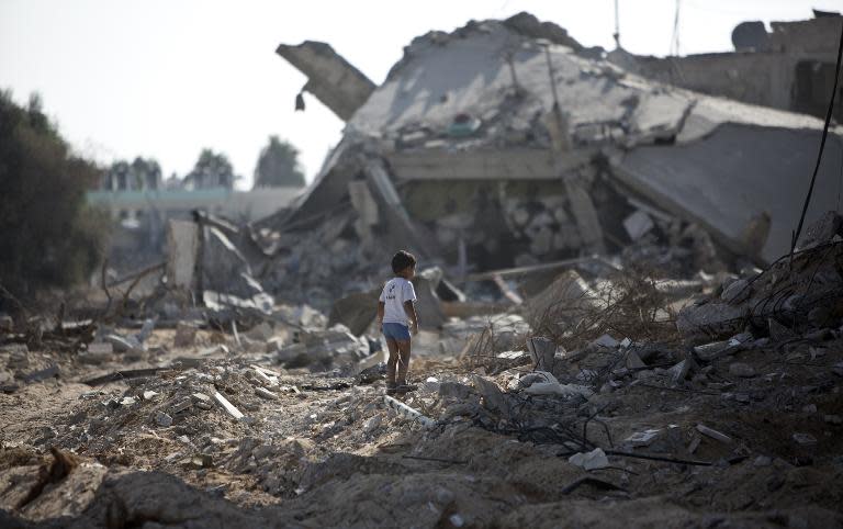 A Palestinian boy walks over debris in Gaza City's Shejaiya neighbourhood, on August 1, 2014