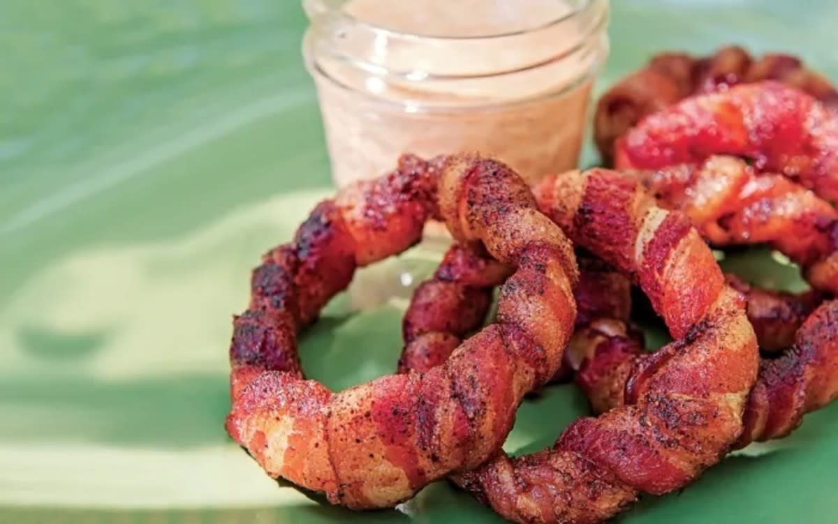 <p>Bill Gillespie</p><p>Forget the batter or breading, these sweet onion rings are wrapped in bacon!</p><p><strong>Get the recipe: <a href="https://parade.com/841721/communitytable/bacon-wrapped-onion-rings/" rel="nofollow noopener" target="_blank" data-ylk="slk:Bacon-Wrapped Onion Rings;elm:context_link;itc:0;sec:content-canvas" class="link rapid-noclick-resp">Bacon-Wrapped Onion Rings</a></strong></p>