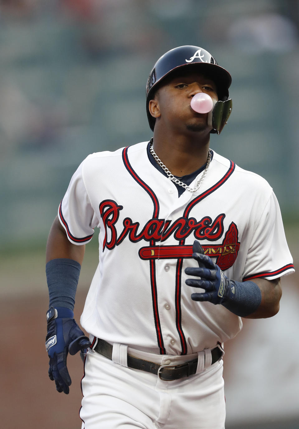 Atlanta Braves left fielder Ronald Acuna Jr. (13) blows a bubble as he rounds the bases after hitting a home run in the first inning of the second baseball game of a doubleheader against the Miami Marlins Monday, Aug. 13, 2018 in Atlanta. (AP Photo/John Bazemore)