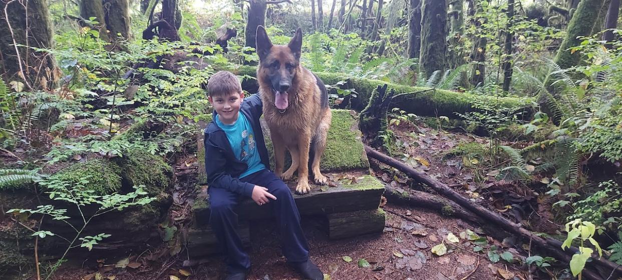 Michael Toulmin is shown with his certified service dog, Thor. Michael is autistic, and Thor helps him regulate his behaviour.  (submitted - image credit)