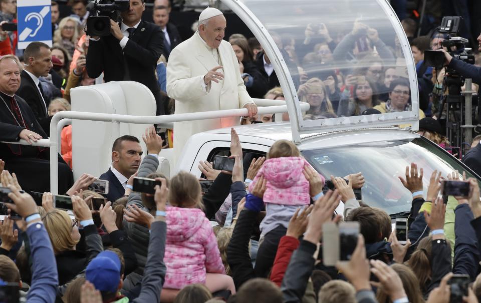 Pope Francis greets faithful as he arrives for a meeting with youths in Vilnius, Lithuania, Saturday, Sept. 22, 2018. Pope Francis begins a four-day visit to the Baltics amid renewed alarm about Moscow's intentions in the region it has twice occupied. (AP Photo/Andrew Medichini)